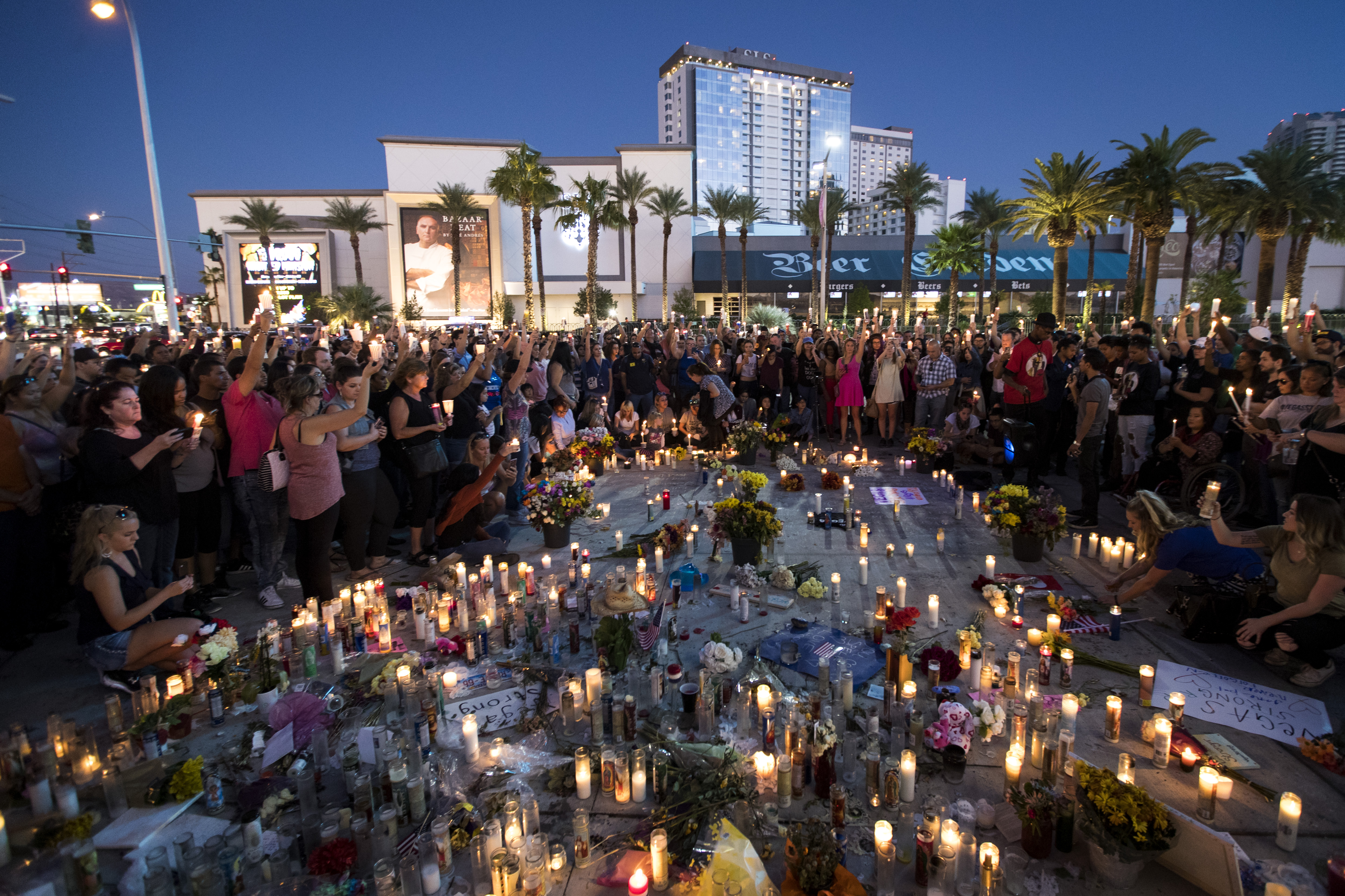 Mourners hold their candles in the air during a moment of silence during a vigil to mark one week since the mass shooting at the Route 91 Harvest country music festival, on the corner of Sahara Avenue and Las Vegas Boulevard at the north end of the Las Vegas Strip, on October 8, 2017, in Las Vegas, Nevada. On October 1, Stephen Paddock killed 58 people and injured more than 450 after he opened fire on a large crowd at the Route 91 Harvest country music festival. The massacre is one of the deadliest mass shooting events in U.S. history. (Source: Drew Angerer/Getty Images)