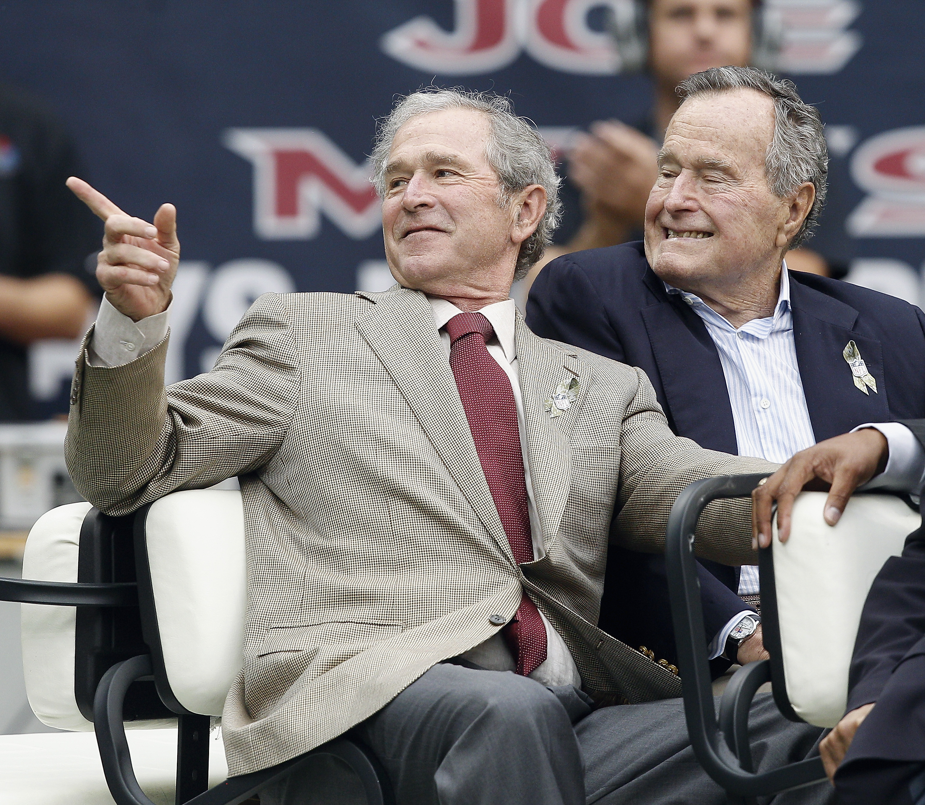 Former Presidents George W. Bush (L) and George H.W. Bush attend a game between the Oakland Raiders and Houston Texans at Reliant Stadium on November 17, 2013 in Houston, Texas.