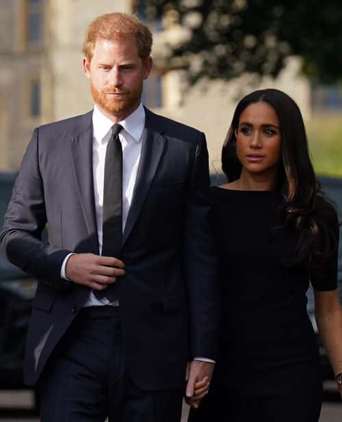 Prince Harry, Duke of Sussex, and Meghan, Duchess of Sussex walk together to meet members of the public on the long Walk at Windsor Castle on September 10, 2022 in Windsor, England. Crowds have gathered and tributes left at the gates of Windsor Castle to Queen Elizabeth II, who died at Balmoral Castle on 8 September, 2022.