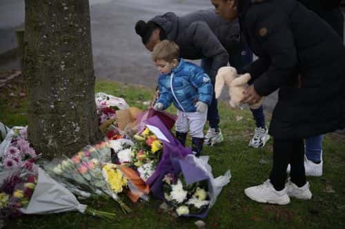 Flowers are left near the scene after three young boys died when a number of children fell through ice on a lake, on December 12, 2022 at Babbs Mill Park in Solihull, England. Three boys aged eight, 10 and 11 have died after falling through an icy lake last night. The search continued for more potential victims, following reports more children were present on the ice at the time of the incident.