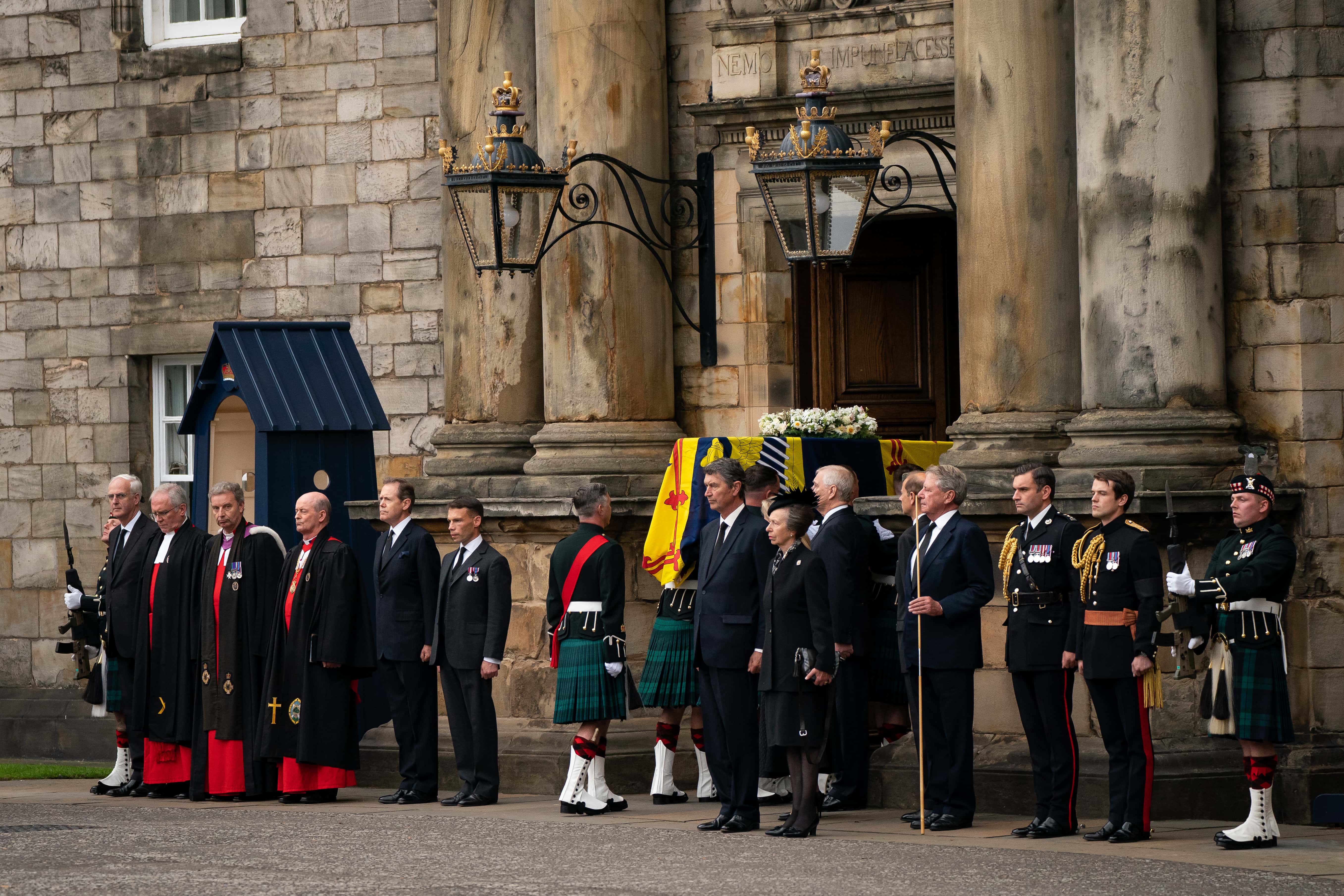 Vice Admiral Timothy Laurence and Britain's Princess Anne, Princess Royal stand solemnly as the coffin of Queen Elizabeth II, draped with the Royal Standard of Scotland, completes its journey from Balmoral to the Palace of Holyroodhouse on September 11, 2022 in Edinburgh, United Kingdom. Elizabeth Alexandra Mary Windsor was born in Bruton Street, Mayfair, London on 21 April 1926. She married Prince Philip in 1947 and ascended the throne of the United Kingdom and Commonwealth on 6 February 1952 after the death of her Father, King George VI. Queen Elizabeth II died at Balmoral Castle in Scotland on September 8, 2022, and is succeeded by her eldest son, King Charles III.
