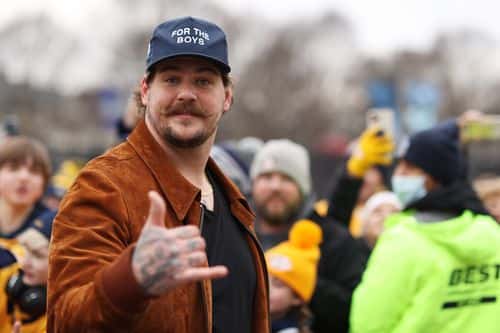 NFL player Taylor Lewan of the Tennessee Titans reacts to the crowd before the 2022 Navy Federal Credit Union NHL Stadium Series between the Tampa Bay Lightning and Nashville Predators at Nissan Stadium on February 26, 2022 in Nashville, Tennessee.
