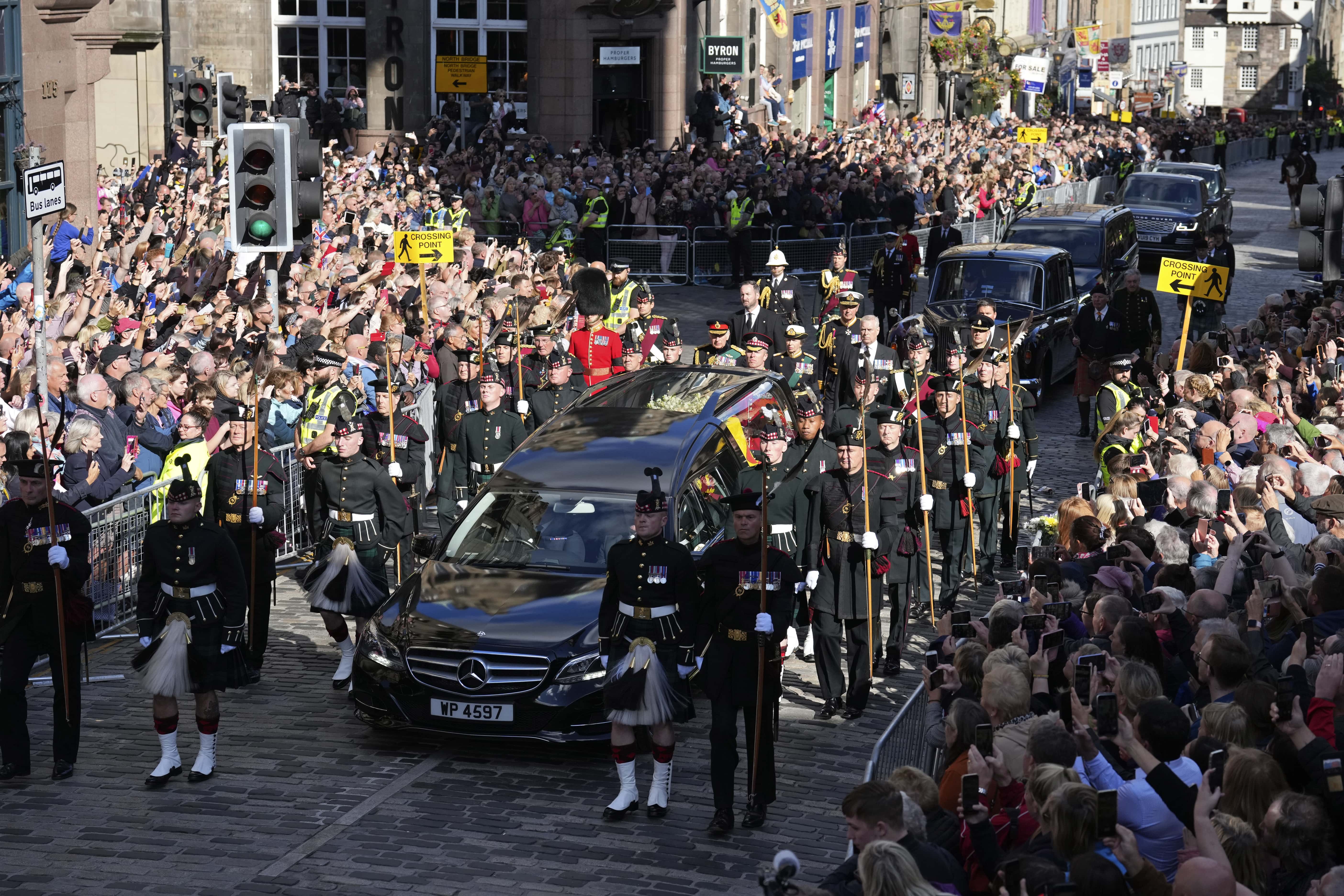 Britain's King Charles III, Britain's Princess Anne, Princess Royal, Britain's Prince Andrew, Duke of York, Britain's Prince Edward, Earl of Wessex and Vice Admiral Timothy Laurence walk behind the hearse carrying Queen Elizabeth II's coffin as it moves along the Royal Mile during the procession from Palace of Holyroodhouse to St Giles' Cathedral on September 12, 2022 in Edinburgh, Scotland. King Charles III joins the procession accompanying Her Majesty The Queen's coffin from the Palace of Holyroodhouse along the Royal Mile to St Giles Cathedral. The King and The Queen Consort, accompanied by other Members of the Royal Family also attend a Service of Prayer and Reflection for the Life of The Queen where it lies in rest for 24 hours before being transferred by air to London.