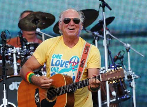 Musician Jimmy Buffett performs onstage at Jimmy Buffett & Friends: Live from the Gulf Coast, a concert presented by CMT at on the beach on July 11, 2010 in Gulf Shores, Alabama.