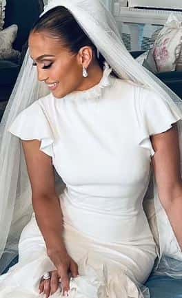 Lopez in her stunning cream Ralph Lauren wedding gown (Screenshot via OnTheJLO.com)