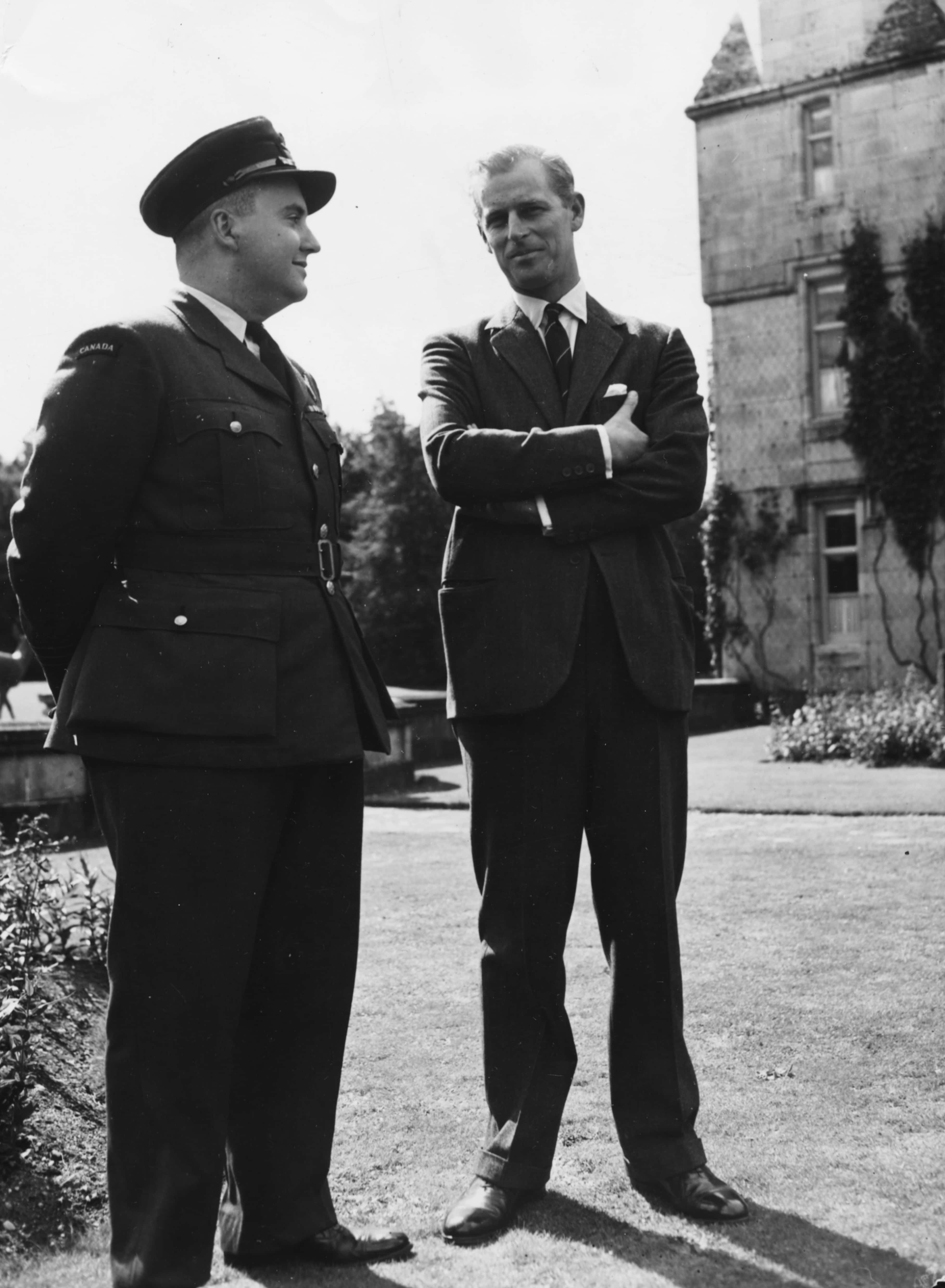 Prince Philip, Duke of Edinburgh (right), talking to Squadron Leader H S Greene of Montreal about the forthcoming Royal visit to Canada, during a visit by Canadian Air Cadets to Balmoral Castle, Scotland, September 1951. (Photo by Fox Photos/Hulton Archive/Getty Images)