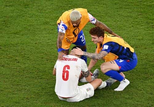 Deandre Yedlin and Josh Sargent of United States embrace Saeid Ezatolahi of IR Iran after the FIFA World Cup Qatar 2022 Group B match between IR Iran and USA at Al Thumama Stadium on November 29, 2022 in Doha, Qatar.