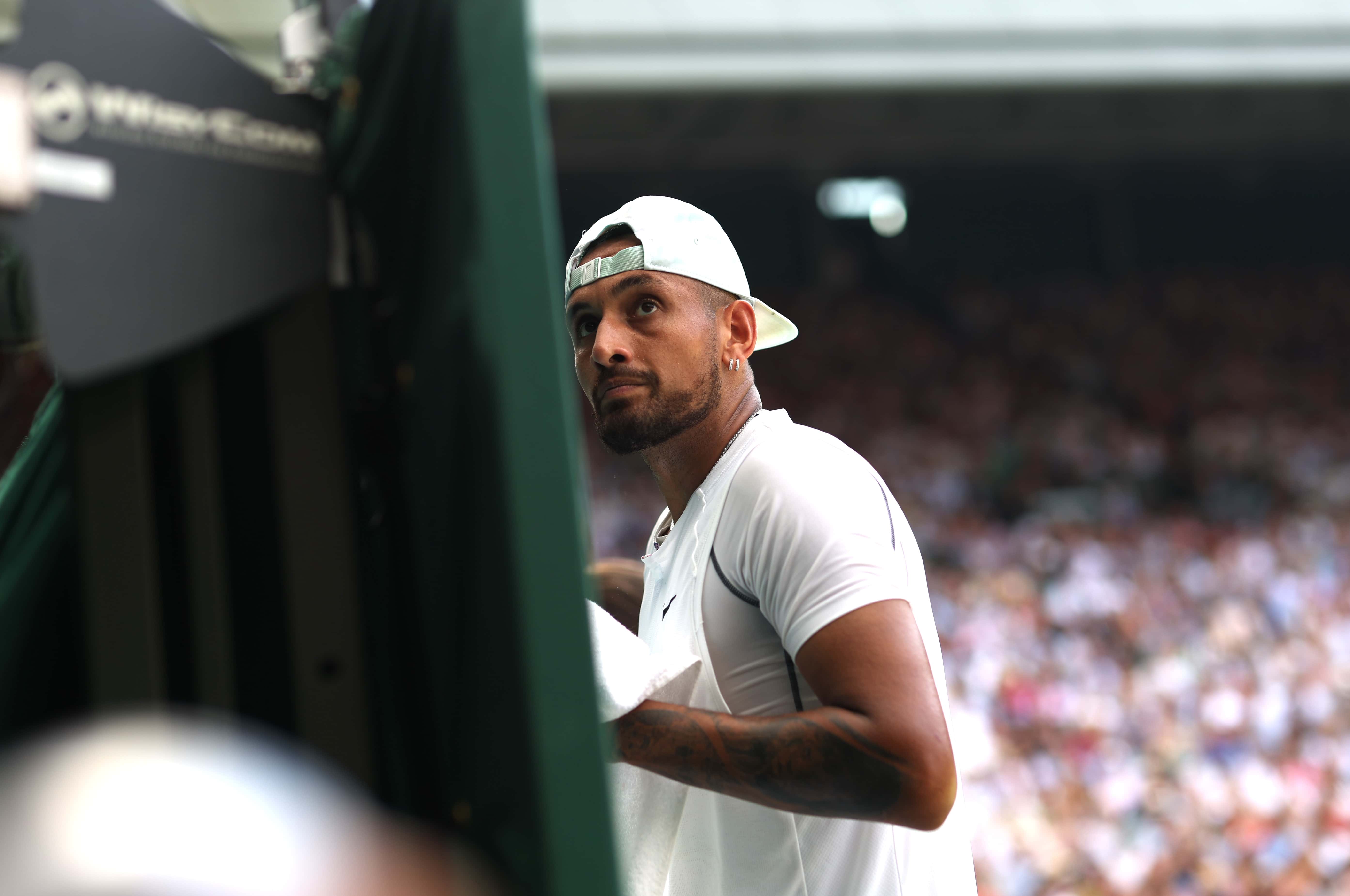 Nick Kyrgios of Australia looks up at umpire Renaud Lichtenstein (out of frame) against Novak Djokovic of Serbia during a changeover in their Men's Singles Final match on day fourteen of The Championships Wimbledon 2022 at All England Lawn Tennis and Croquet Club on July 10, 2022 in London, England.