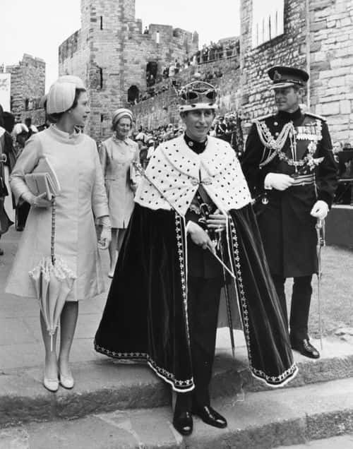 Prince Charles (centre) wearing a coronet and robes after a ceremony where he was invested as the Prince of Wales, with Queen Elizabeth II (left) and the Duke of Edinburgh (right) at Caernarvon Castle, Wales, July 2nd 1969. (Photo by Dennis Oulds/Central Press/Hulton Archive/Getty Images)