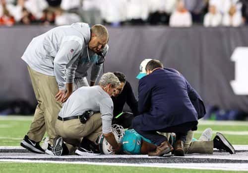Medical staff tend to quarterback Tua Tagovailoa #1 of the Miami Dolphins after an injury during the 2nd quarter of the game against the Cincinnati Bengals at Paycor Stadium on September 29, 2022 in Cincinnati, Ohio.