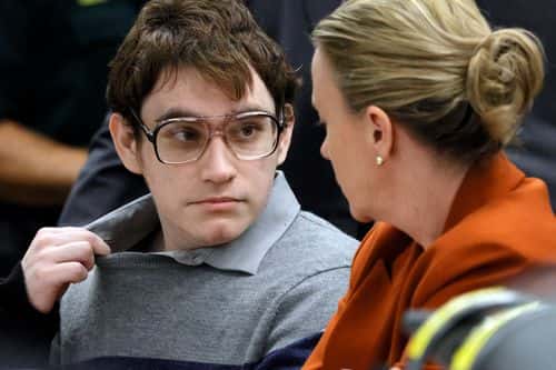 Marjory Stoneman Douglas High School shooter Nikolas Cruz tugs at his shirt collar as he is seated at the defense table for the verdict in his trial at the Broward County Courthouse October 13, 2022 in Fort Lauderdale, Florida.Cruz, who plead guilty to 17 counts of premeditated murder in the 2018 shootings, is the most lethal mass shooter to stand trial in the U.S. He was previously sentenced to 17 consecutive life sentences without the possibility of parole for 17 additional counts of attempted murder for the students he injured that day.