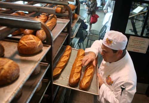 Boudin Bakery master baker Fernando Padilla checks loaves of freshly baked sourdough bread at Boudin Bakery April 21, 2008 in San Francisco, California. Boudin, the oldest continuously operating business in San Francisco and the original Sourdough French bread maker is being forced to raise prices on its popular sourdough bread as the cost of flour has nearly tripled in the past year due to high wheat prices caused by strong worldwide demand and increased price speculation.