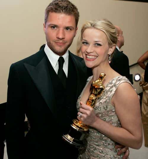 Actress and winner Reese Witherspoon poses with her Oscar and husband Ryan Phillippe (L) as they attend the Governor's Ball after the 78th Annual Academy Awards at The Highlands on March 5, 2006 in Hollywood, California.