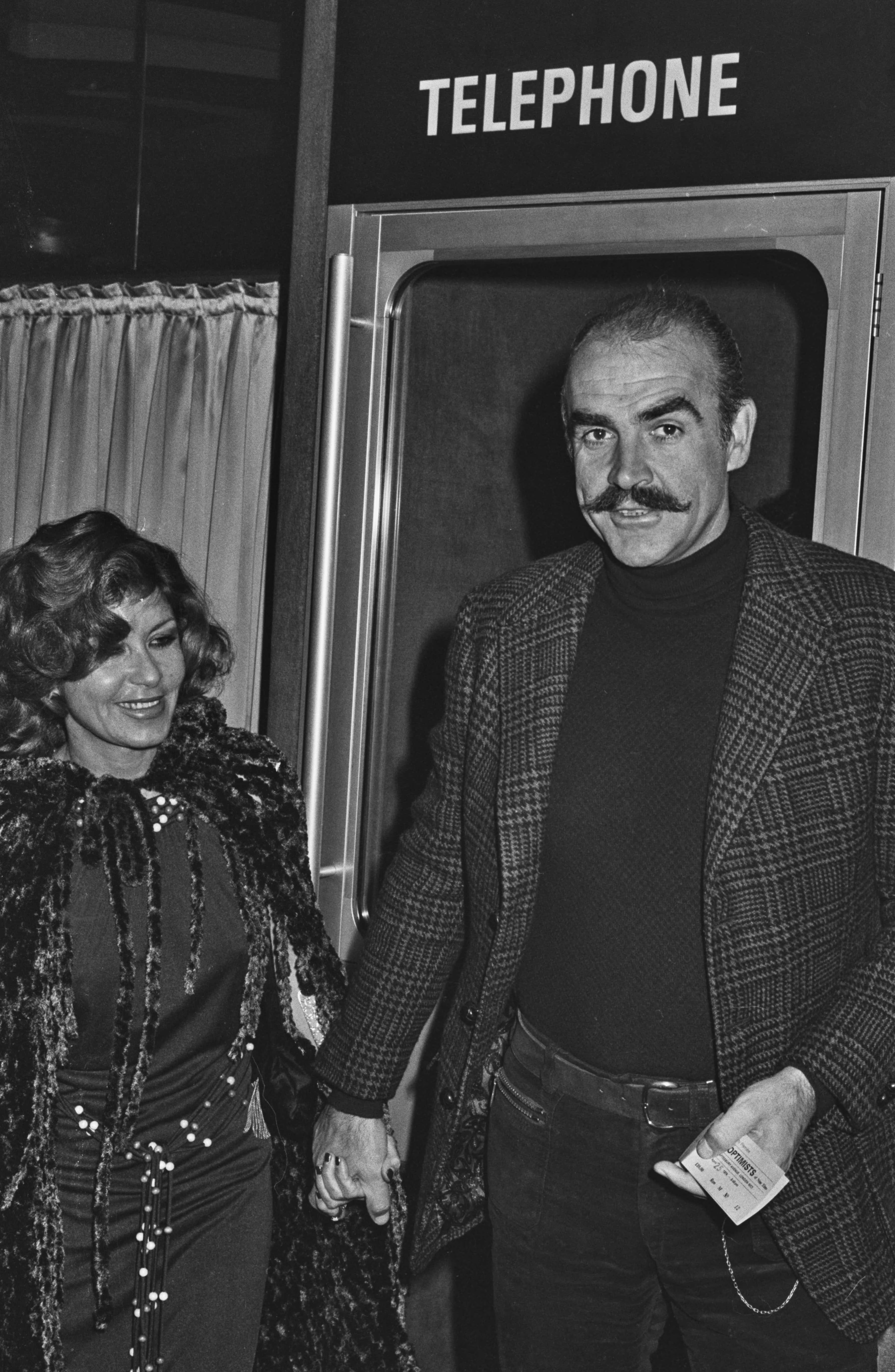 Scottish actor Sean Connery (1930 - 2020) and his partner Micheline Roquebrune (later his wife) at the charity premiere of 'The Optimists of Nine Elms' at the ABC Cinema in London, UK, 25th April 1974.  (Photo by Larry Ellis/Express/Hulton Archive/Getty Images)
