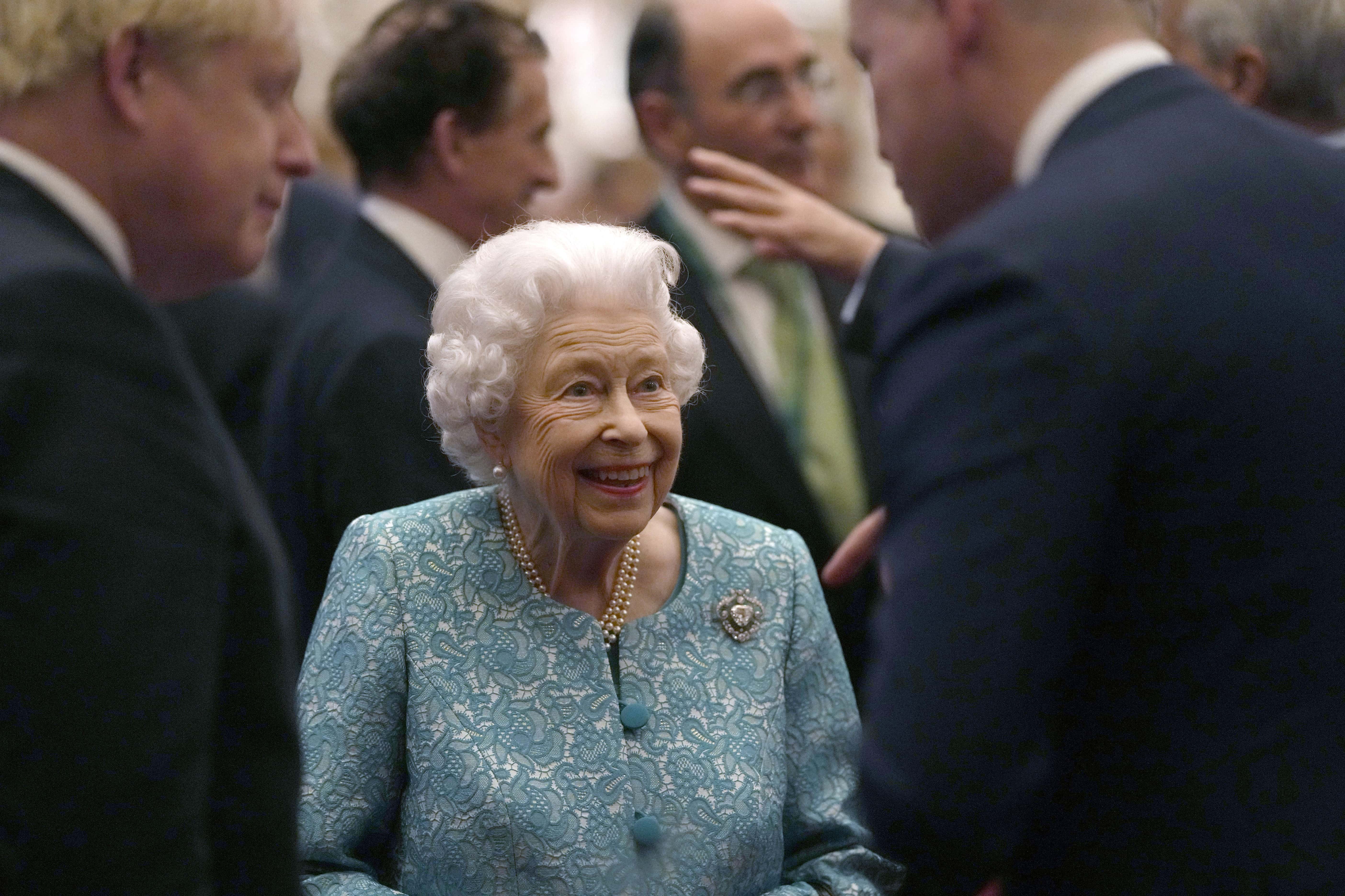 Britain's Queen Elizabeth II and Prime Minister, Boris Johnson greet guests during a reception for international business and investment leaders at Windsor Castle to mark the Global Investment Summit on October 19, 2021 in Windsor, England.