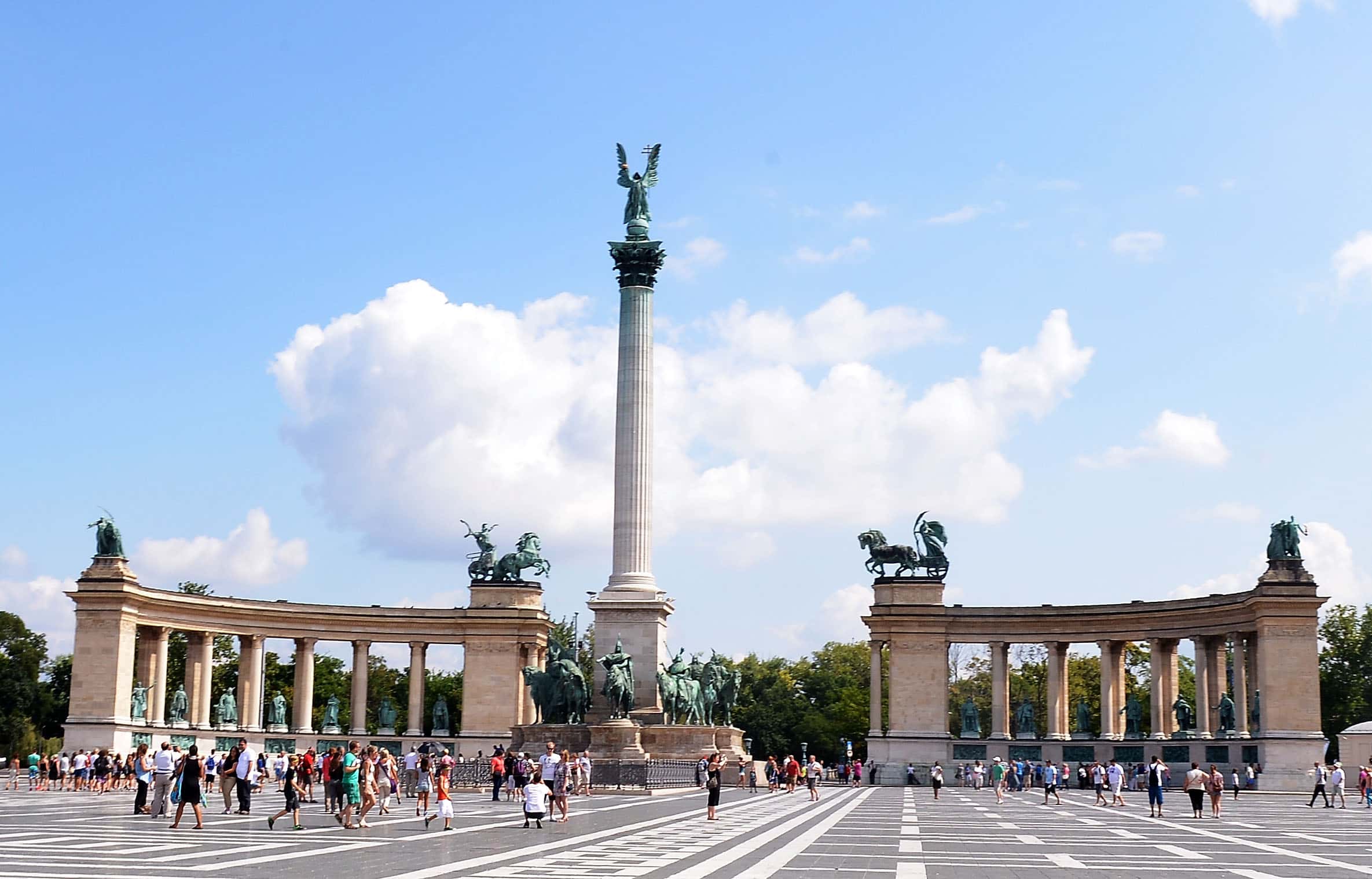 Tourists and locals walk across Heroes' Square past Millenium Monument during previews ahead of the Hungarian Formula One Grand Prix on July 24, 2014 in Budapest, Hungary.