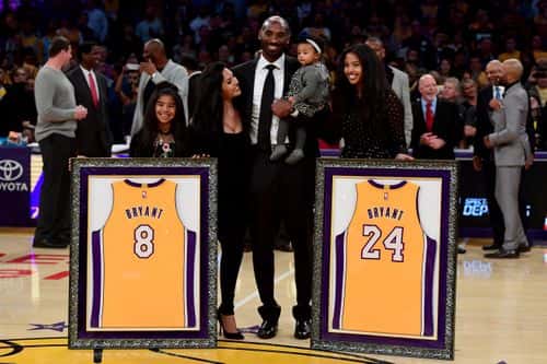 Kobe Bryant poses with his family at halftime after both his #8 and #24 Los Angeles Lakers jerseys are retired at Staples Center on December 18, 2017 in Los Angeles, California. NOTE TO USER: User expressly acknowledges and agrees that, by downloading and or using this photograph, User is consenting to the terms and conditions of the Getty Images License Agreement.