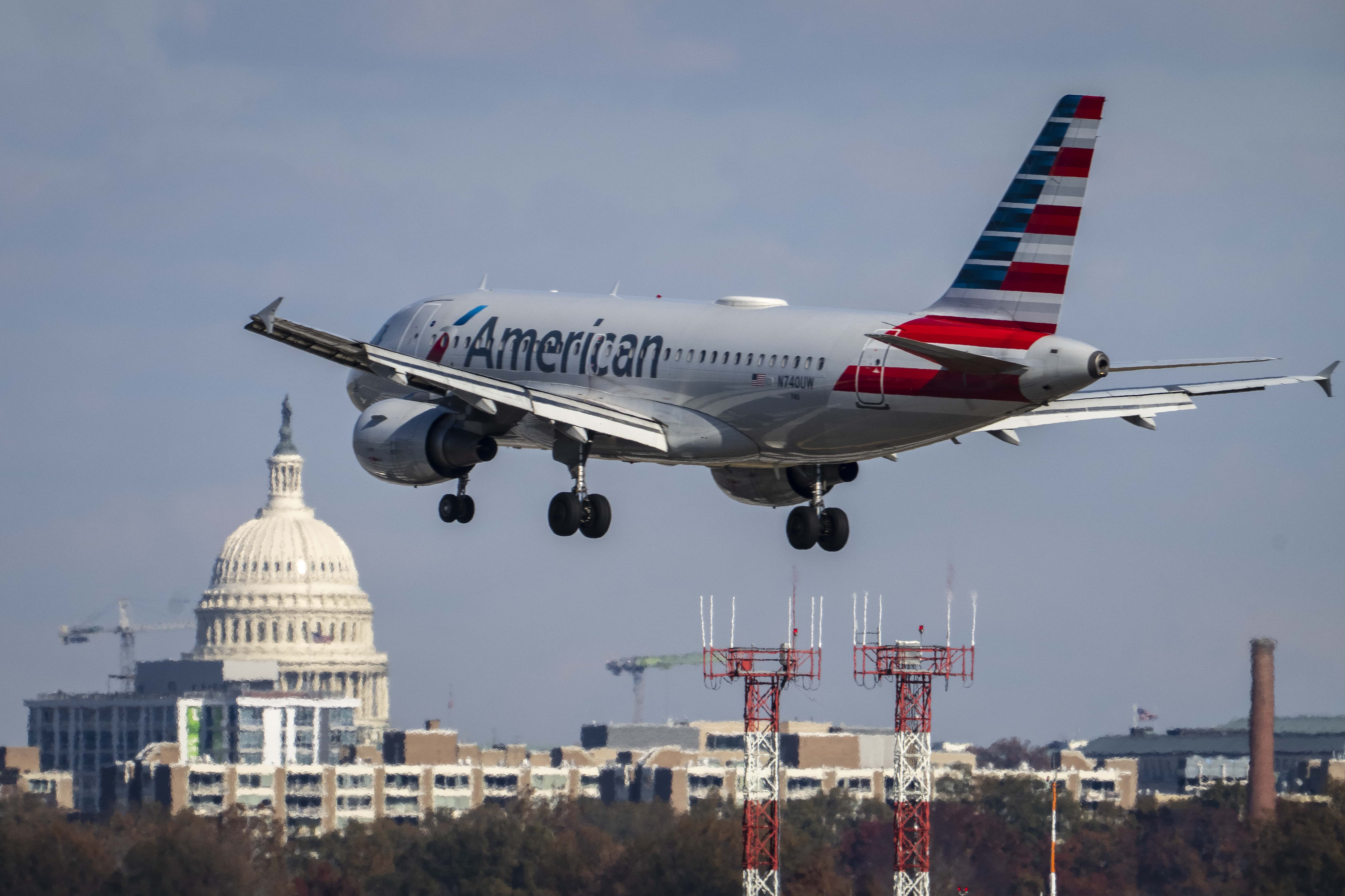 An American Airlines plane lands at Ronald Reagan Washington National Airport November 23, 2021 in Arlington, Virginia. With Covid-19 vaccinations on the rise and Americans now traveling more freely, U.S. airports and airlines are expecting millions more passengers this holiday season compared to 2020.