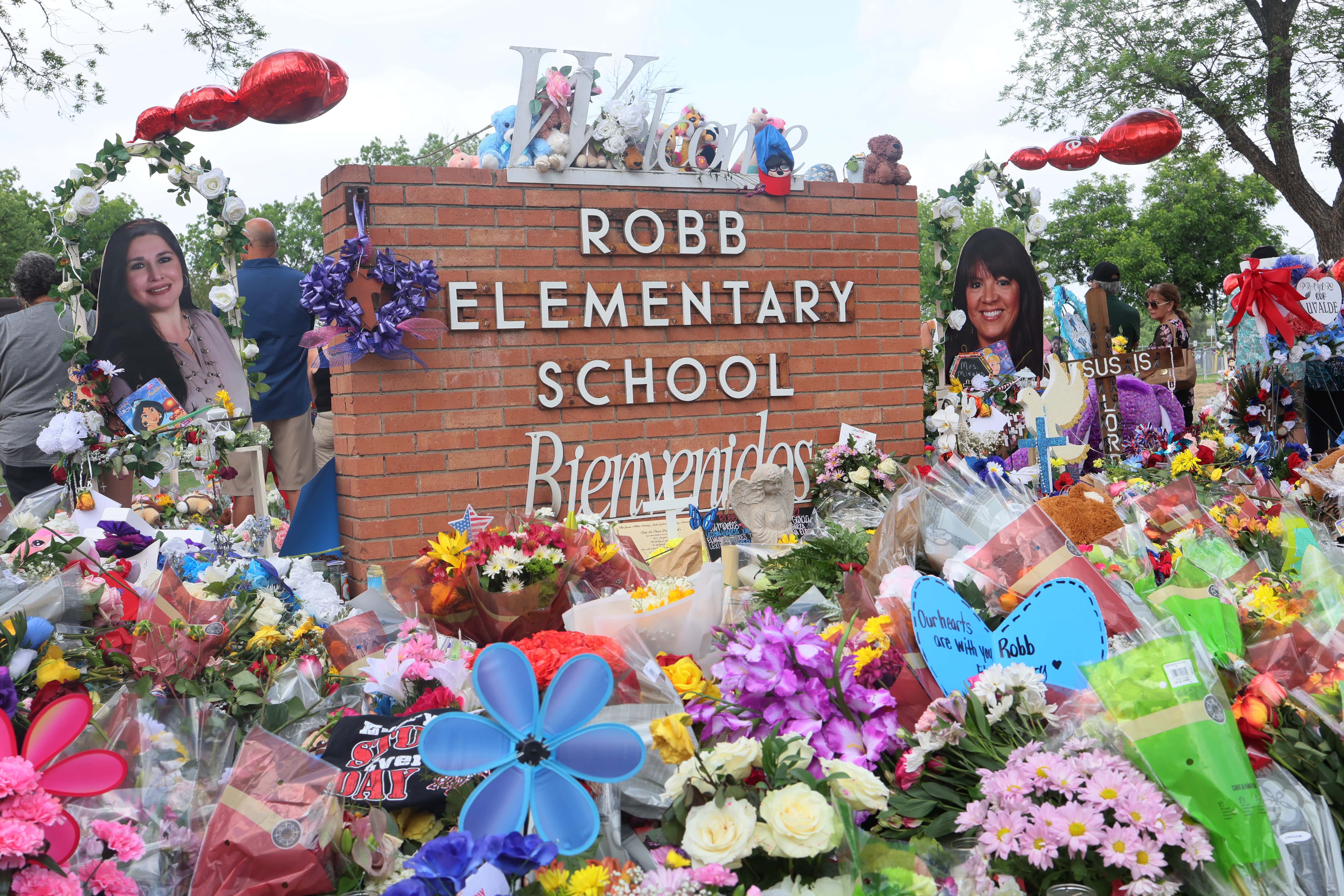 People visit a memorial for the 19 children and two adults killed on May 24th during a mass shooting at Robb Elementary School on May 30, 2022 in Uvalde, Texas. Visitations for Amerie Jo Garza and Maite Rodriguez, two of the 19 children killed in the May 24th Robb Elementary School mass shooting are being held today. Wakes and funerals for the 21 victims will be scheduled throughout the week.