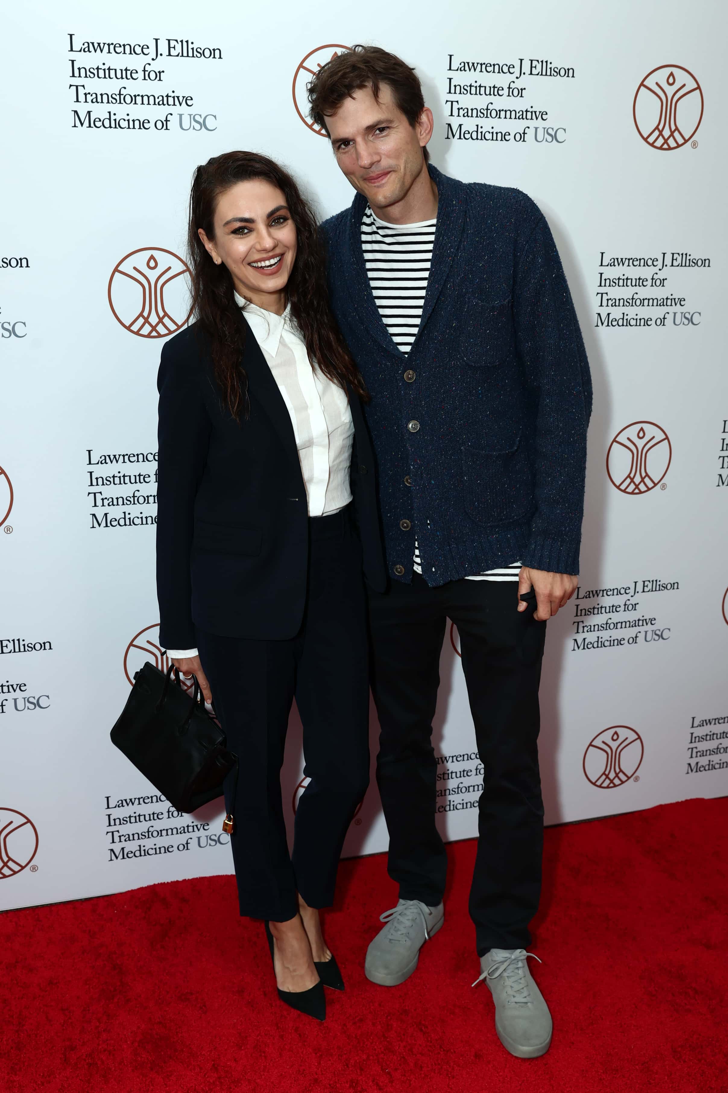 Mila Kunis and Ashton Kutcher attend the Grand Opening of the Lawrence J. Ellison Institute on September 28, 2021 in Los Angeles, California.