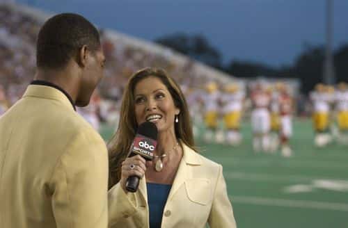 ABC's Monday Night Football sideline reporter Lisa Guerrero interviews Pro Football Hall of Fame enshrinee Marcus Allen during the Hall of Fame game between the Green Bay Packers and the Kansas City Chiefs at Fawcett Stadium on August 4, 2003 in Canton, Ohio.  The Chiefs held 9-0 lead when game was called due to unsuitable weather conditions.