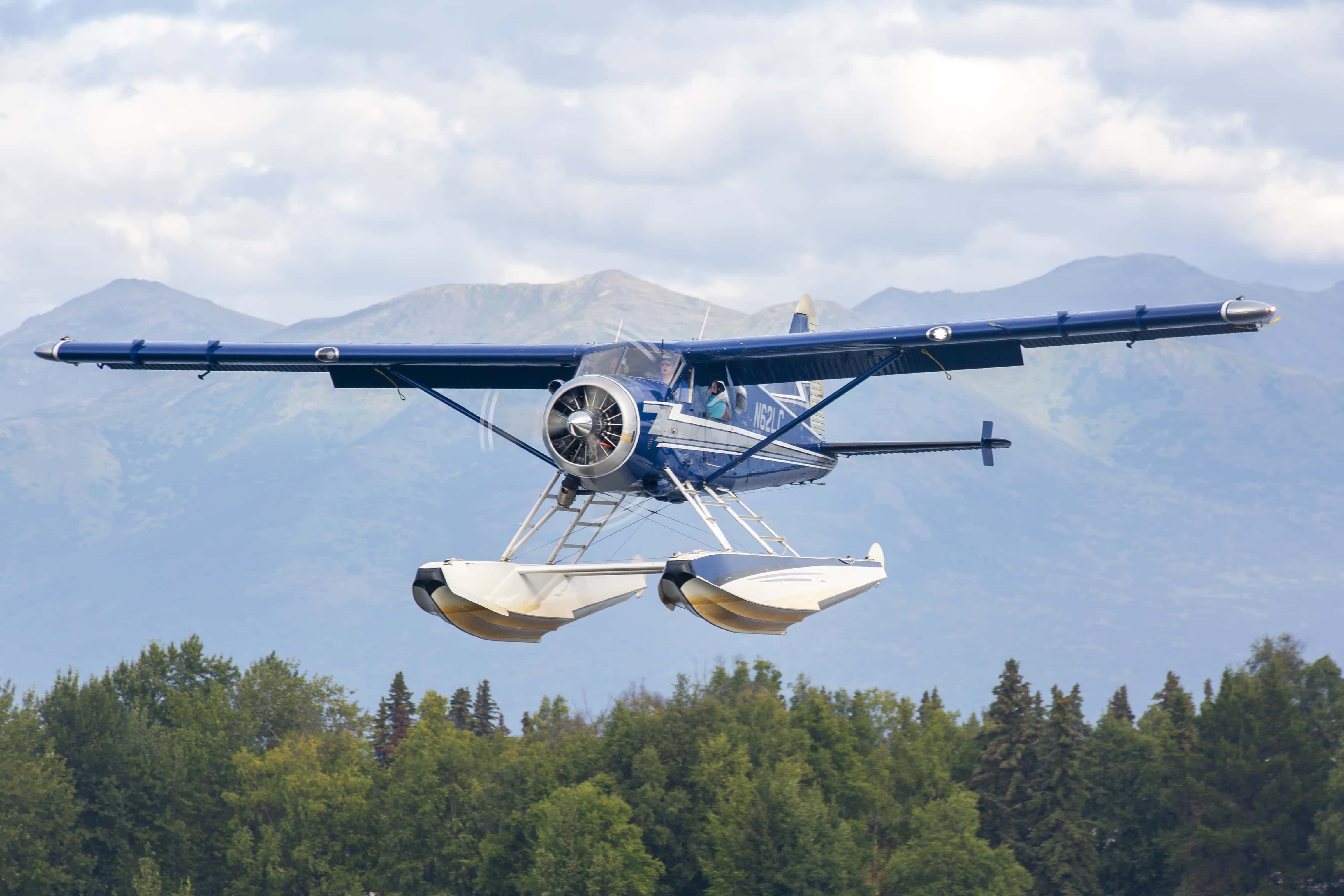This image is of a blue Beaver aircraft landing at lake hood sea plane base. The de Havilland Canada DHC-2 Beaver is a single-engined high-wing propeller-driven short takeoff and landing (STOL) aircraft developed and manufactured by de Havilland Canada. It has been primarily operated as a bush plane and has been used for a wide variety of utility roles, such as cargo and passenger hauling, aerial application (crop dusting and aerial topdressing), and civil aviation duties.