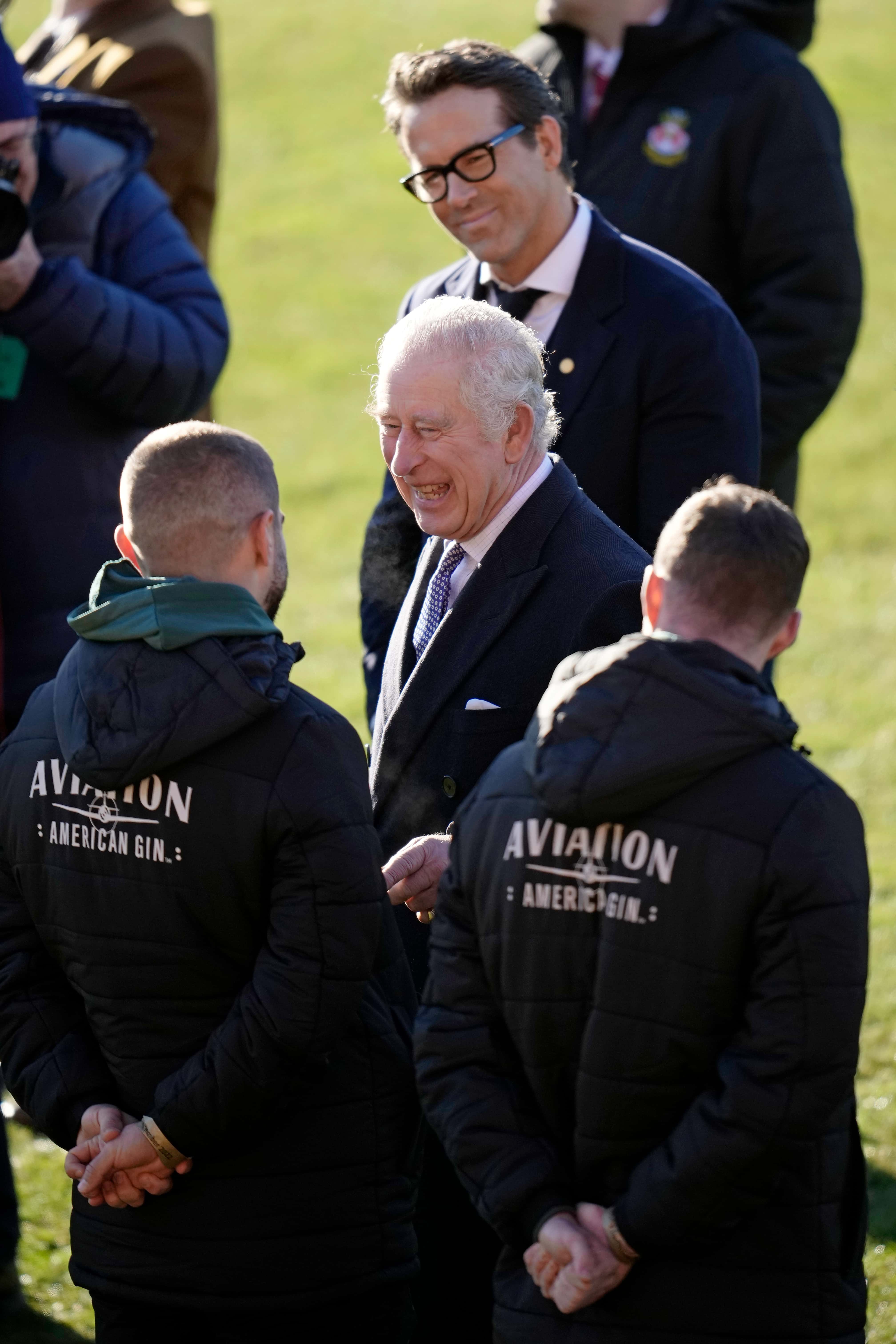 King Charles III and Co-Owner Wrexham AFC Ryan Reynolds talk to players during their visit to Wrexham AFC on December 09, 2022 in Wrexham, Wales. Formed in 1864, Wrexham AFC is the third oldest professional football team in the world. The club was taken over by Hollywood actors Ryan Reynolds and Rob McElhenney in late 2020.