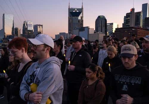 People take part in a procession following a citywide vigil for the victims killed in a mass shooting at the Covenant School on March 29, 2023 in Nashville, Tennessee. A 28-year-old former student of the private Christian school, wielding a handgun and two AR-style weapons, shot and killed three 9-year-old students and three adults before being killed by responding police officers.