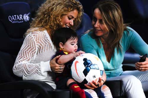 Shakira and Montserrat Bernabeu, Gerard Pique's mother, play with Milan prior to the La Liga match between FC Barcelona and Sevilla FC at Camp Nou on September 14, 2013 in Barcelona, Spain.