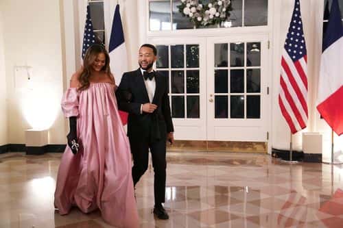John Legend and Chrissy Teigen arrive for the White House state dinner for French President Emmanuel Macron at the White House on December 1, 2022 in Washington, DC. The official state visit is the first of the Biden administration.