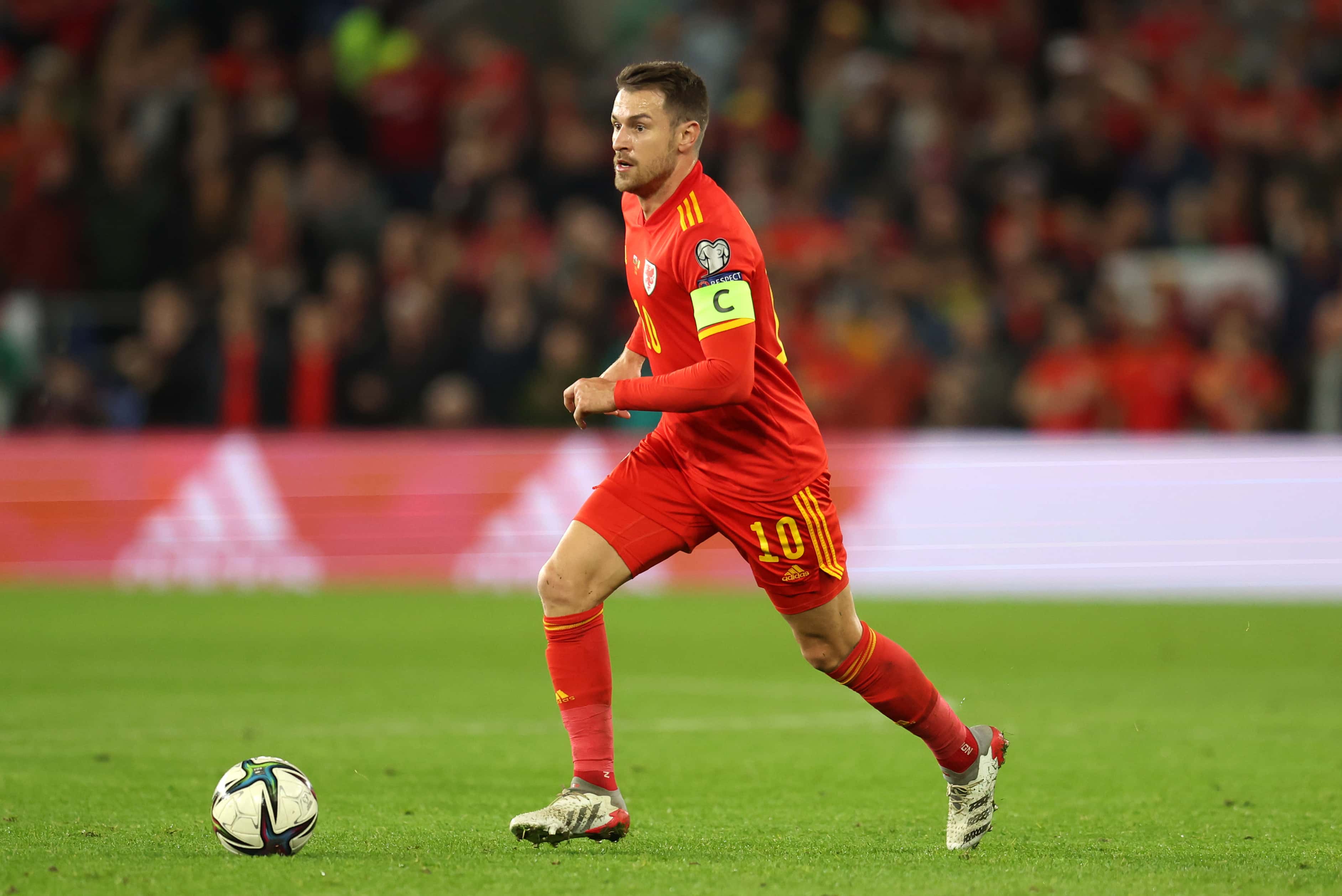 Aaron Ramsey of Wales runs with the ball during the 2022 FIFA World Cup Qualifier match between Wales and Belgium at Cardiff City Stadium on November 16, 2021 in Cardiff, Wales.