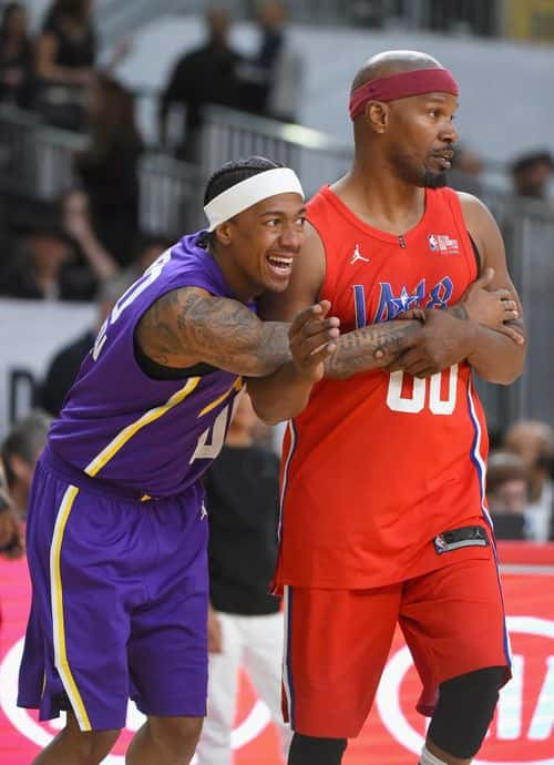 Nick Cannon (L) and Jamie Foxx vie for position during the 2018 NBA All-Star Game Celebrity Game at Los Angeles Convention Center on February 16, 2018 in Los Angeles, California.