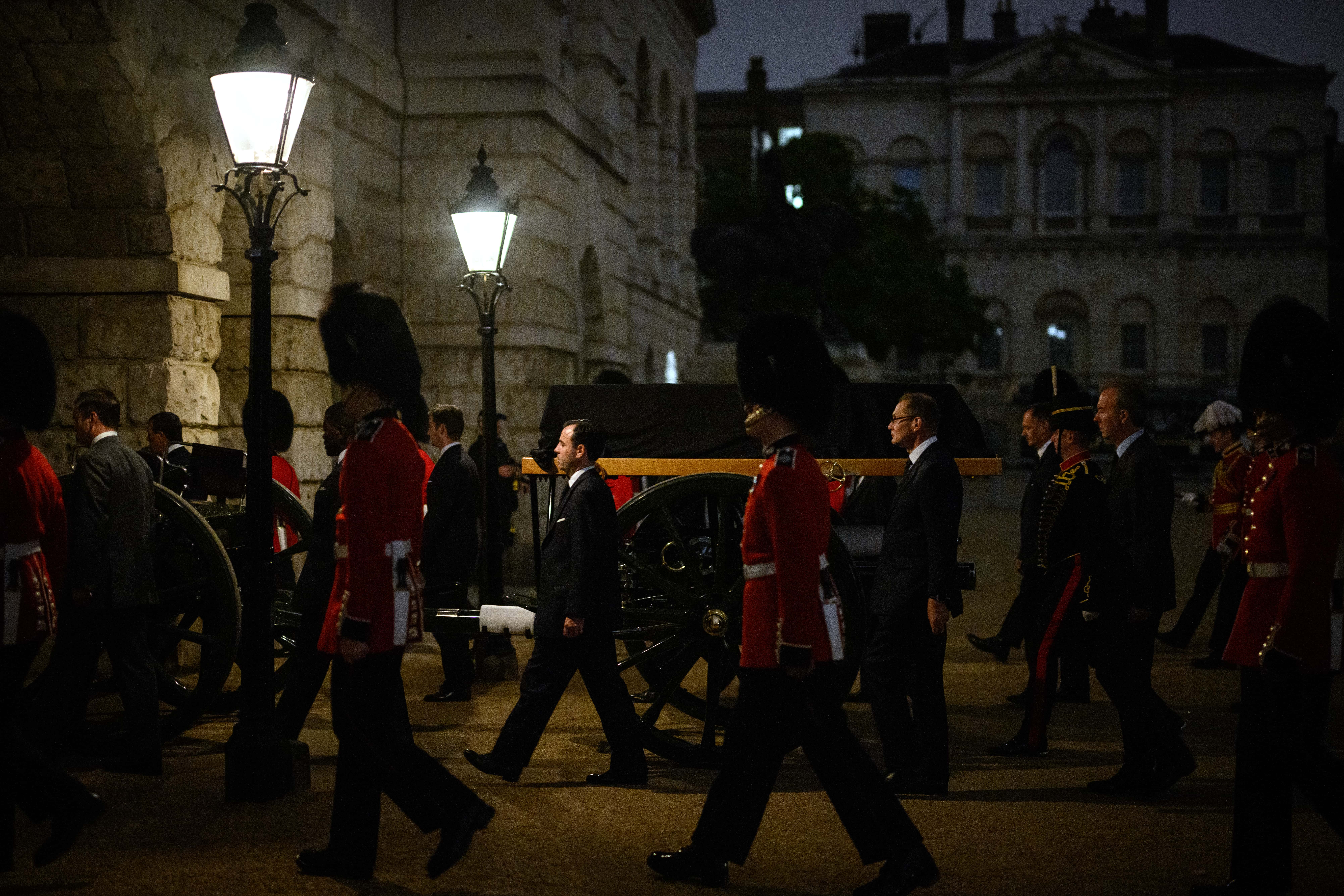 An empty coffin is seen on a carriage as Guardsmen march from Buckingham Palace to the Palace of Westminster during an early morning rehearsal of tomorrow's funeral procession, on September 13, 2022 in London, England. Her Majesty Queen Elizabeth II's coffin will be transferred from Buckingham Palace by gun carriage in a ceremonial procession taking place on Wednesday 14th September. Queen Elizabeth II died at Balmoral Castle in Scotland on September 8, 2022, and is succeeded by her eldest son, King Charles III.