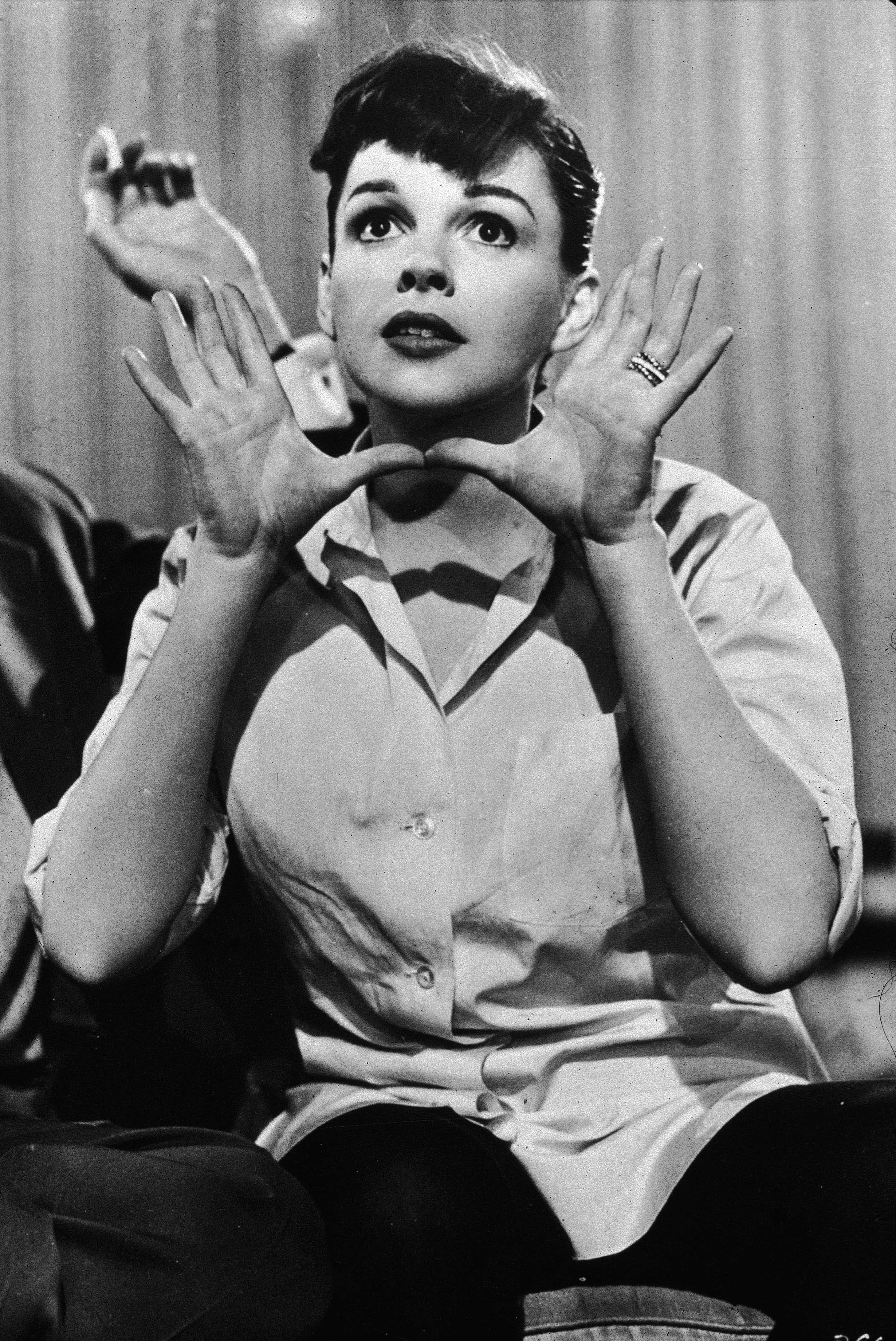American actor and singer Judy Garland (1922-1969) holds her hands up near her face, circa 1950s.(Ph