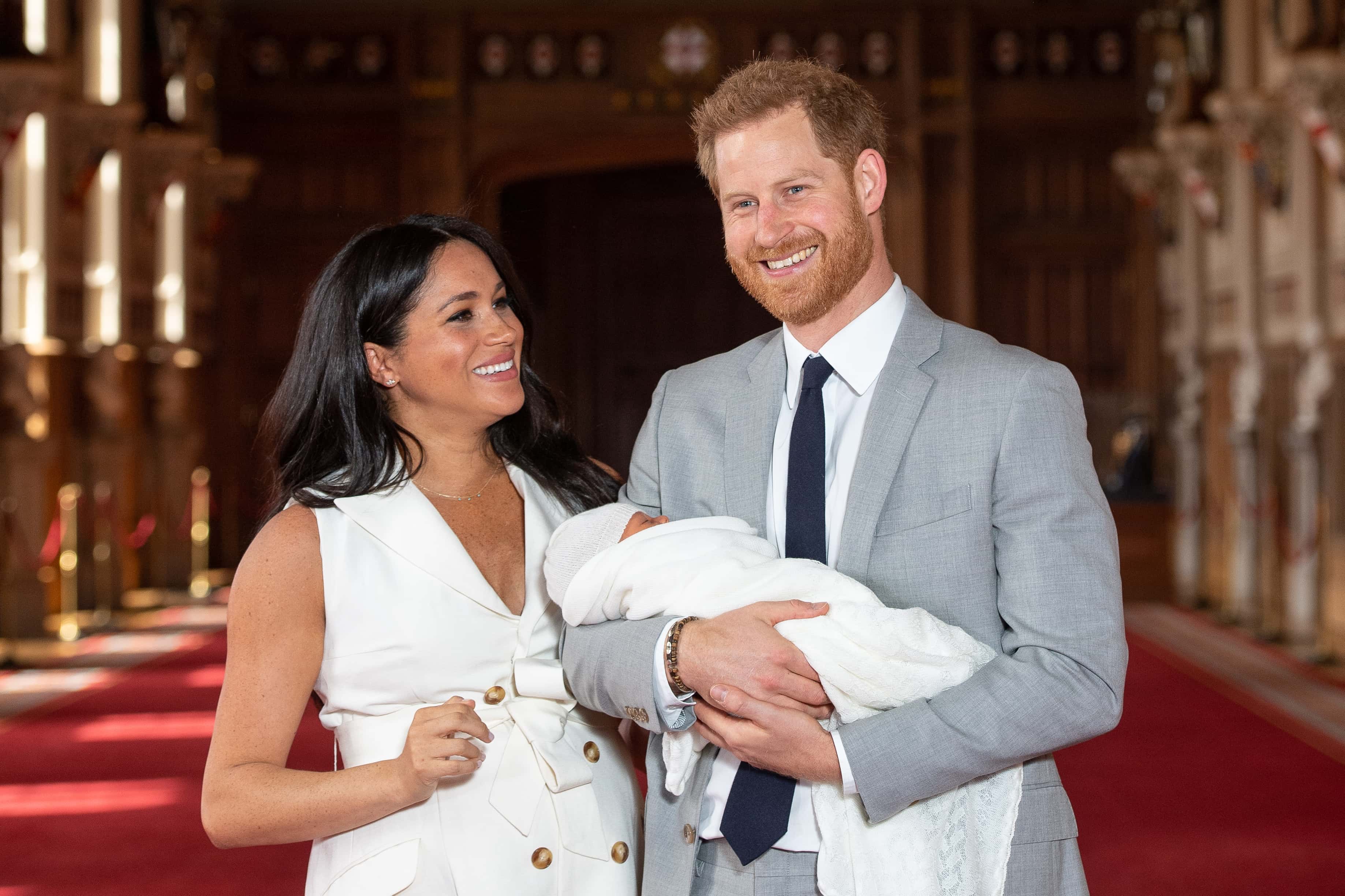 Prince Harry, Duke of Sussex and Meghan, Duchess of Sussex, pose with their newborn son Archie Harrison Mountbatten-Windsor during a photocall in St George's Hall at Windsor Castle on May 8, 2019 in Windsor, England. The Duchess of Sussex gave birth at 05:26 on Monday 06 May, 2019.