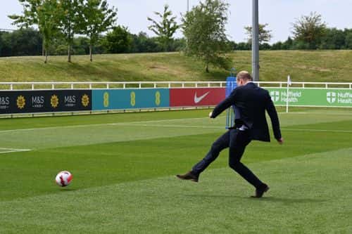 Prince William, Duke of Cambridge scores a goal whilst visiting the England Women's football team at St. George's Park on June 15, 2022 in Burton upon Trent, England.