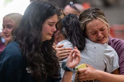 Community members mourn together at a vigil for the 21 victims in the mass shooting at Robb Elementary School on May 25, 2022 in Uvalde, Texas. Nineteen students and two adults were killed, with the gunman fatally shot by law enforcement.