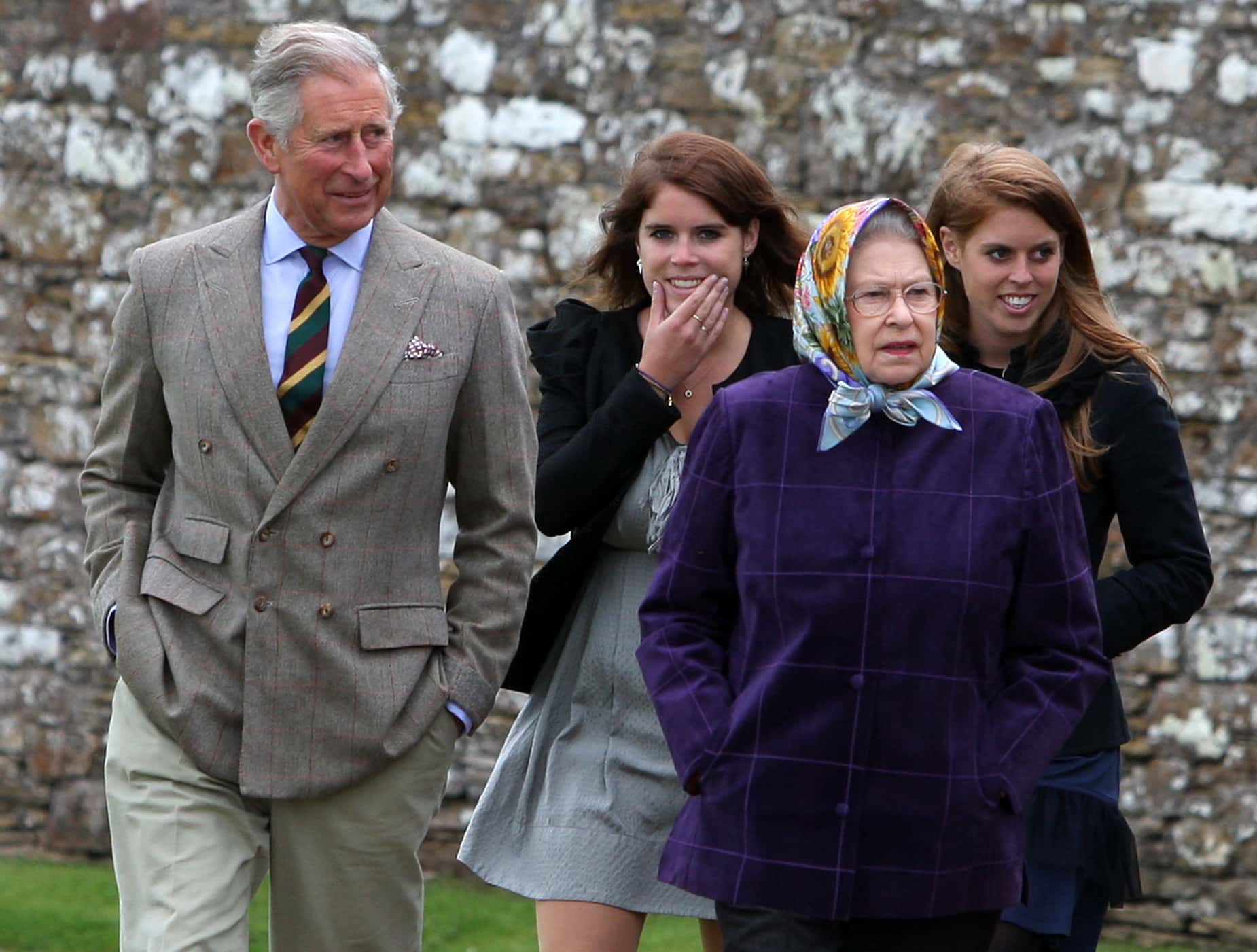 Queen Elizabeth II (R) accompanied by Prince Charles, Prince of Wales (L), Princess Eugenie, (C), and Princess Beatrice and the rest of the Royal family arrive at the Castle of Mey after disembarking the Hebridean Princess boat after a private family holiday around the Western Isles of Scotland, on August 02, 2010 in Scrabster, Scotland.