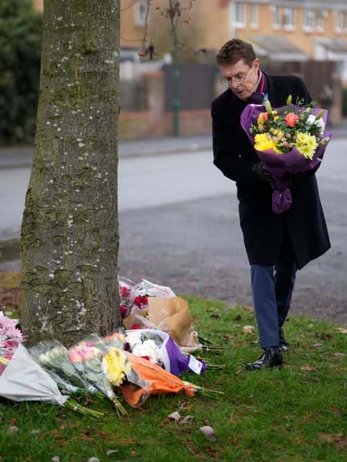 West Midlands Mayor Andy Street lays flowers near the scene after three young boys died when a number of children fell through ice on a lake, on December 12, 2022 at Babbs Mill Park in Solihull, England. Three boys aged eight, 10 and 11 have died after falling through an icy lake last night. The search continued for more potential victims, following reports more children were present on the ice at the time of the incident.