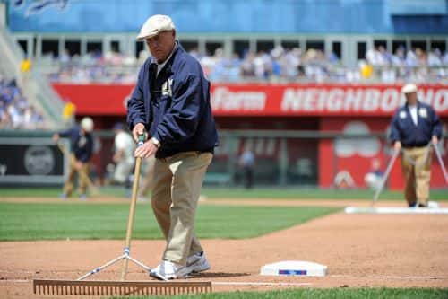 Former Kansas City Royals heads groundskeeper George Toma tends to the field between inning during a game between the New York Yankees and Kansas City Royals  at Kauffman Stadium on May 17, 2015 in Kansas City, Missouri.