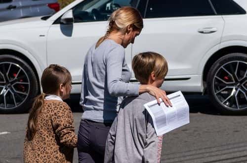 A parent walks with their kids from Woodmont Baptist Church where children were reunited with their families after a mass shooting at The Covenant School on March 27, 2023 in Nashville, Tennessee. According to initial reports, three students and three adults were killed by the shooter, a 28-year-old woman. The shooter was killed by police responding to the scene.