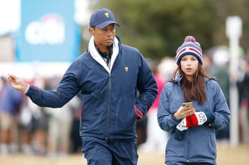 Playing Captain Tiger Woods of the United States team and girlfriend Erica Herman look on during Saturday four-ball matches on day three of the 2019 Presidents Cup at Royal Melbourne Golf Course on December 14, 2019 in Melbourne, Australia.