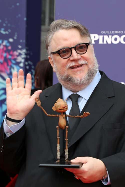 Director Guillermo del Toro poses with a small replica of Pinocchio during the