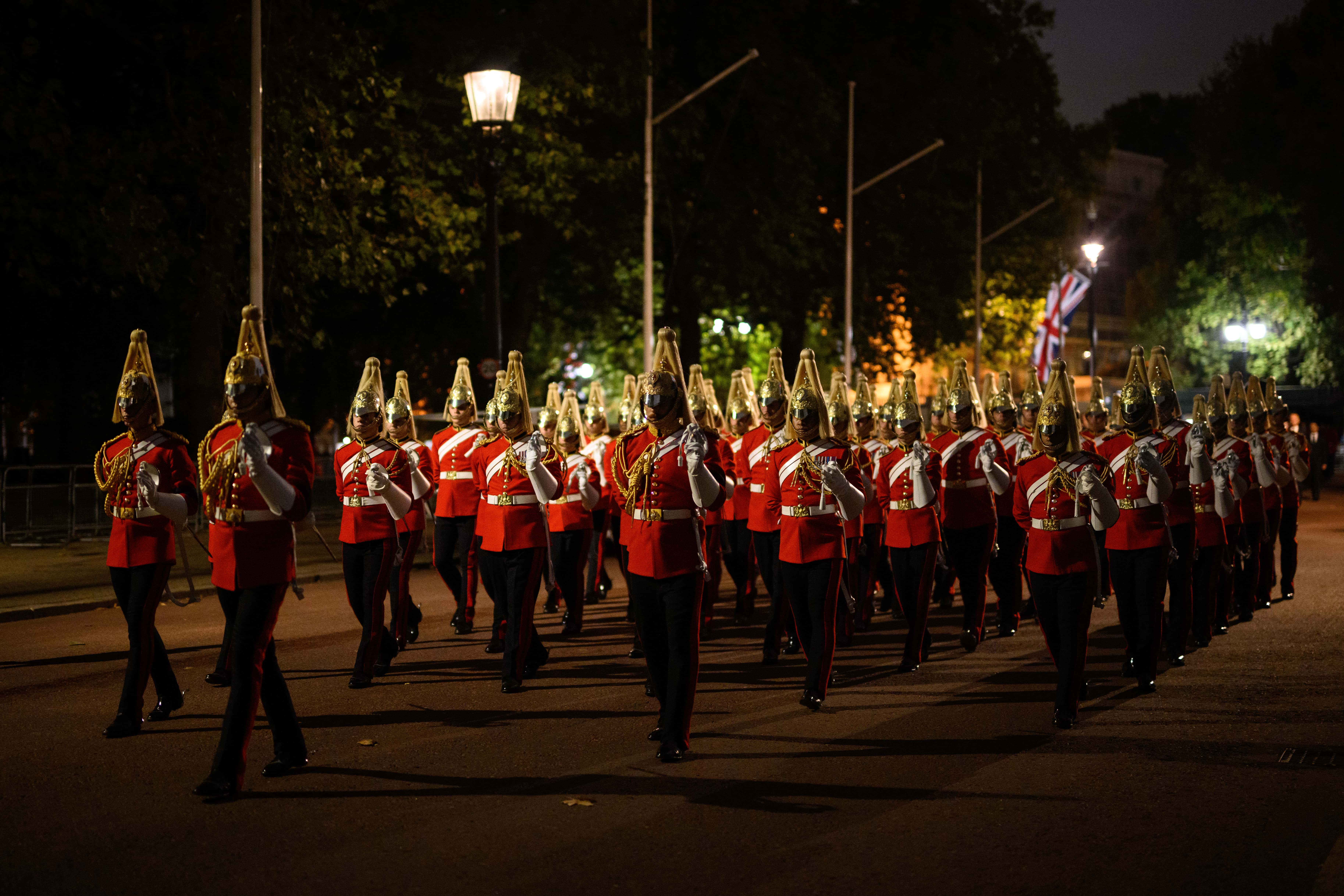 Guardsmen march from Buckingham Palace to the Palace of Westminster during an early morning rehearsal of tomorrow's funeral procession, on September 13, 2022 in London, England. Her Majesty Queen Elizabeth II's coffin will be transferred from Buckingham Palace by gun carriage in a ceremonial procession taking place on Wednesday 14th September. Queen Elizabeth II died at Balmoral Castle in Scotland on September 8, 2022, and is succeeded by her eldest son, King Charles III.