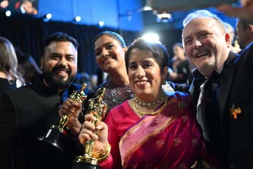 In this handout photo provided by A.M.P.A.S., (CL-CR) Kartiki Gonsalves and Guneet Monga, winners of the Best Documentary Short Subject award for