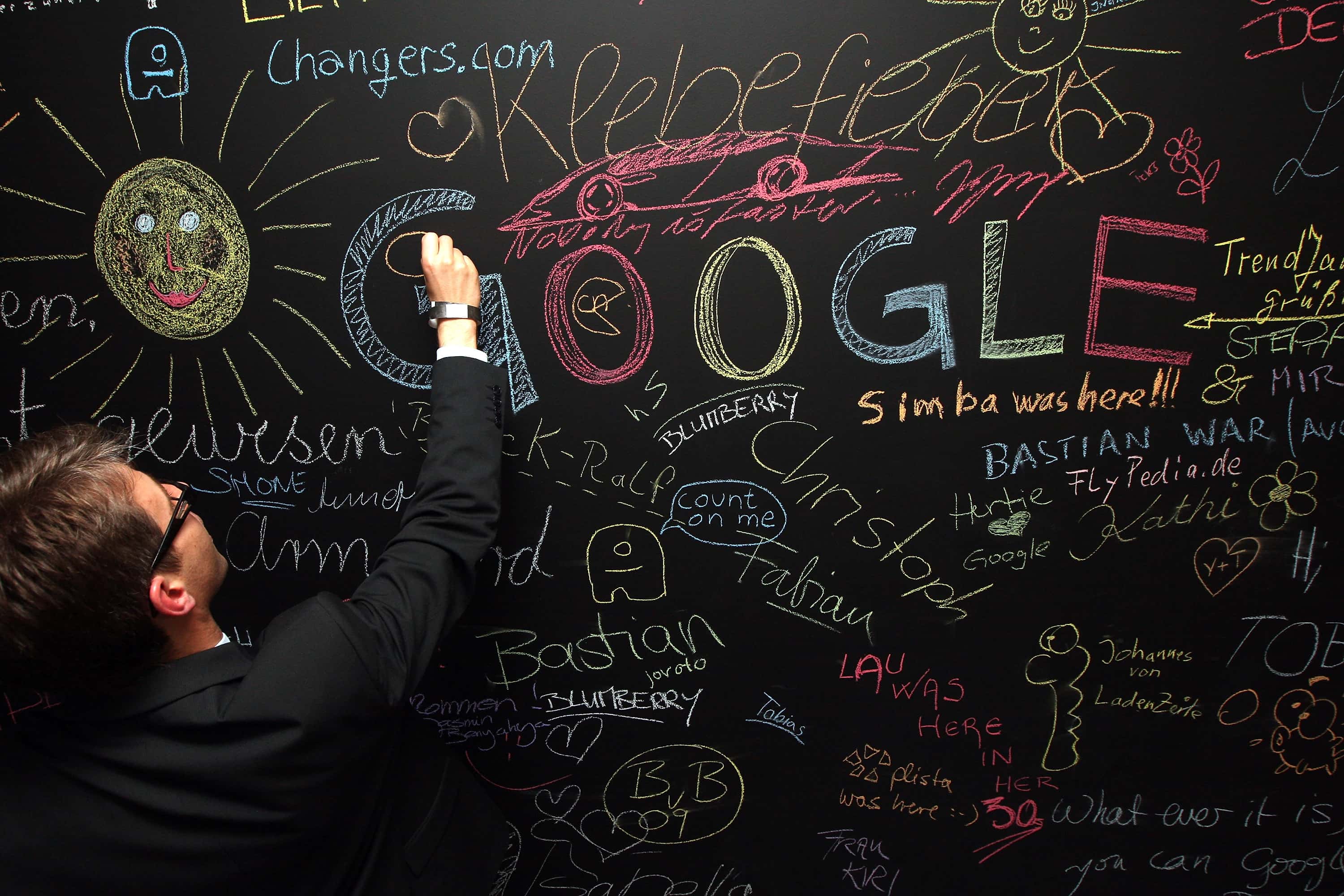 A visitor writes on a chalkboard on September 26, 2012 at the official opening party of the Google offices in Berlin, Germany. Although the American company holds 95% of the German search engine market share and already has offices in Hamburg and Munich, its new offices on the prestigious Unter den Linden avenue are its first in the German capital. The Internet giant has been met with opposition in the country recently by the former president's wife, who has sued it based on search results for her name that she considers derogative.  The European Commission has planned new data privacy regulations in a country where many residents opted in to have their homes pixeled out when the company introduced its Street View technology.