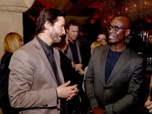 Actors Keanu Reeves (L) and Lance Reddick talk at the after party for the screening of Lionsgate Films'