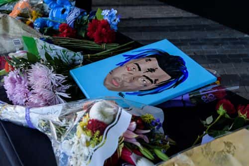 Fans leave items at a makeshift memorial outside the XXXTentacion Funeral & Fan Memorial at BB&T Center on June 27, 2018 in Sunrise, Florida.