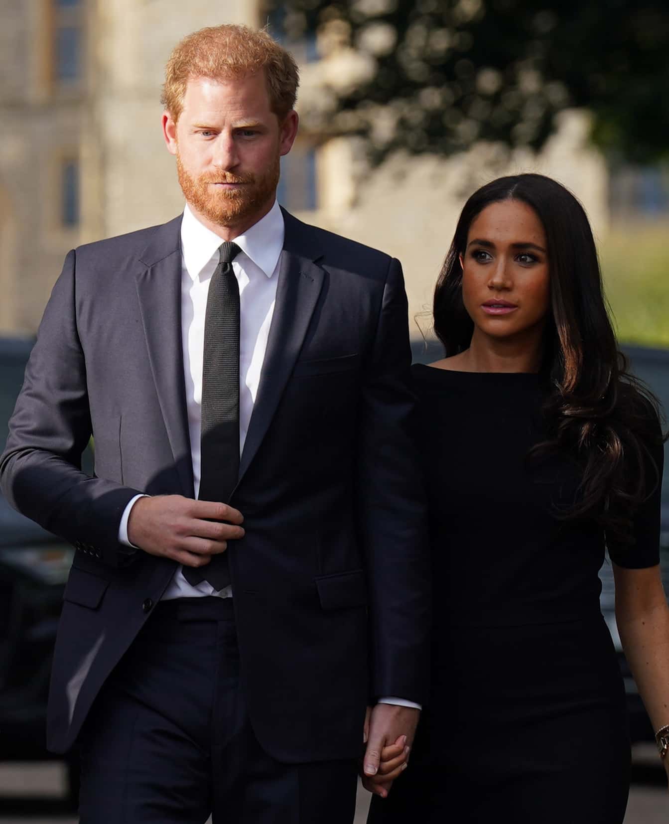 Prince Harry, Duke of Sussex, and Meghan, Duchess of Sussex walk together to meet members of the public on the long Walk at Windsor Castle on September 10, 2022 in Windsor, England. Crowds have gathered and tributes left at the gates of Windsor Castle to Queen Elizabeth II, who died at Balmoral Castle on 8 September, 2022.