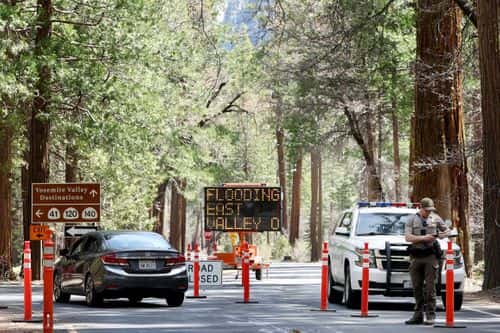 A park ranger works at a checkpoint for a road closed due to flooding in Yosemite Valley, as warming temperatures have increased snowpack runoff, on April 29, 2023 in Yosemite National Park, California. Most of Yosemite Valley is now closed because of the risk of extensive flooding from the melting snowpack amid a heat wave. As of April 1, snowpack in the Tuolumne River basin of Yosemite National Park was 244% of average amid record snowpack levels for some parts of California after years of drought.